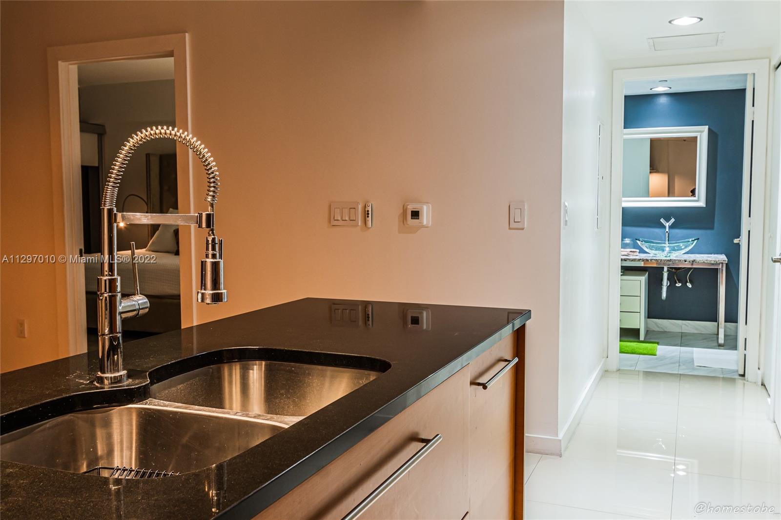 485 Brickell Avenue, Unit 3003 Miami, FL 33131 - Photo 17 of 17 a kitchen that has a sink and a stove