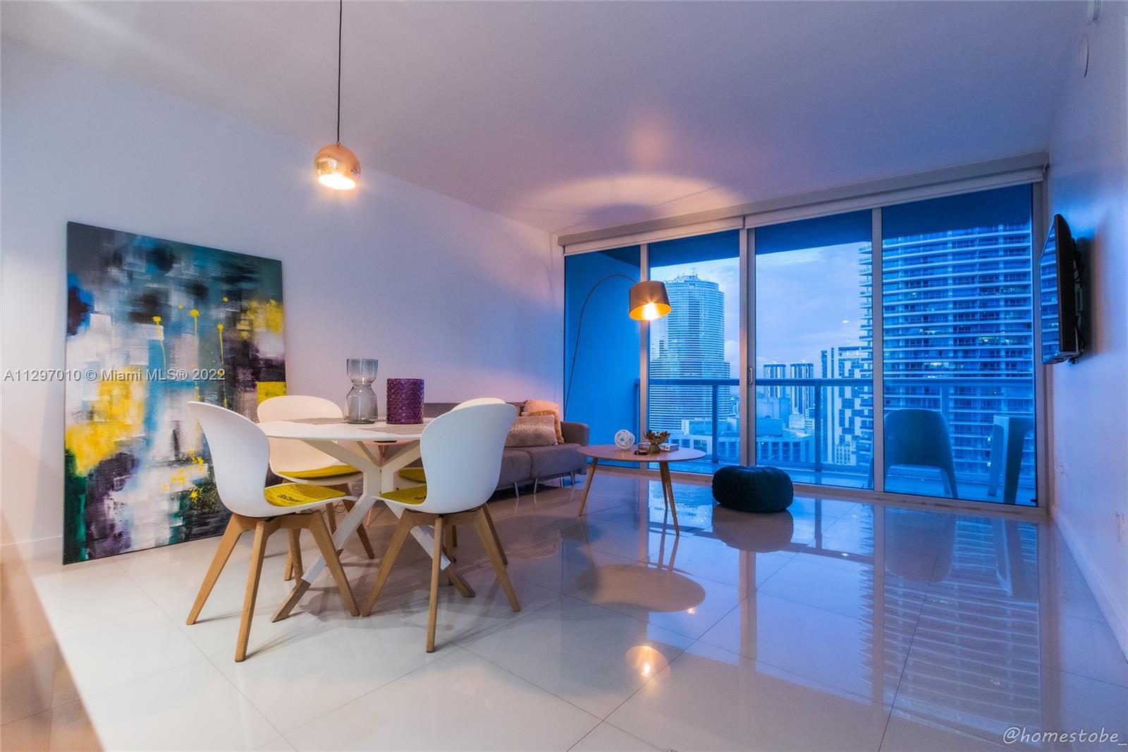485 Brickell Avenue, Unit 3003 Miami, FL 33131 - Photo 5 of 17 a dining room with furniture and wooden floor