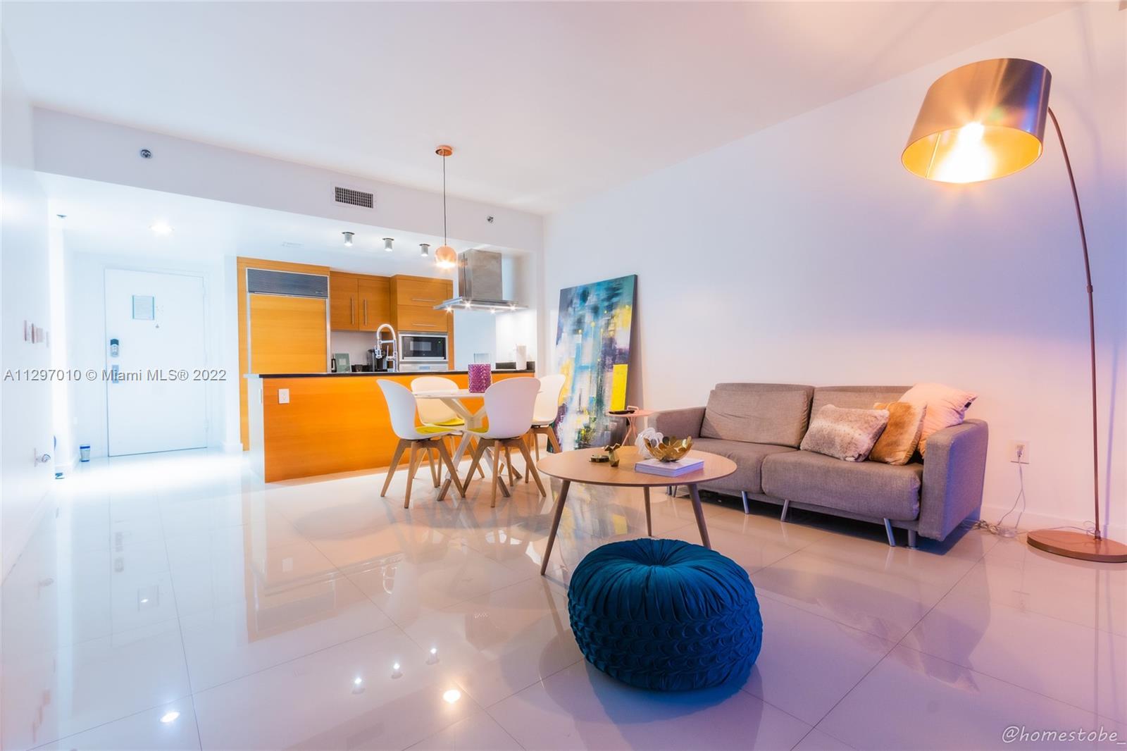 485 Brickell Avenue, Unit 3003 Miami, FL 33131 - Photo 7 of 17 a living room with furniture and a chandelier