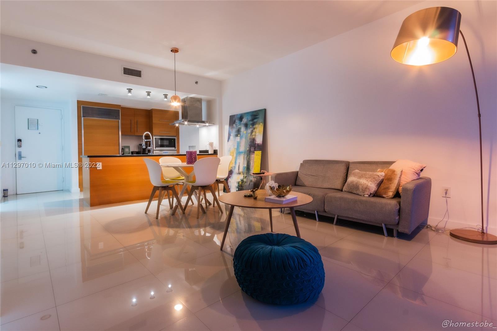 485 Brickell Avenue, Unit 3003 Miami, FL 33131 - Photo 8 of 17 a living room with furniture and a chandelier