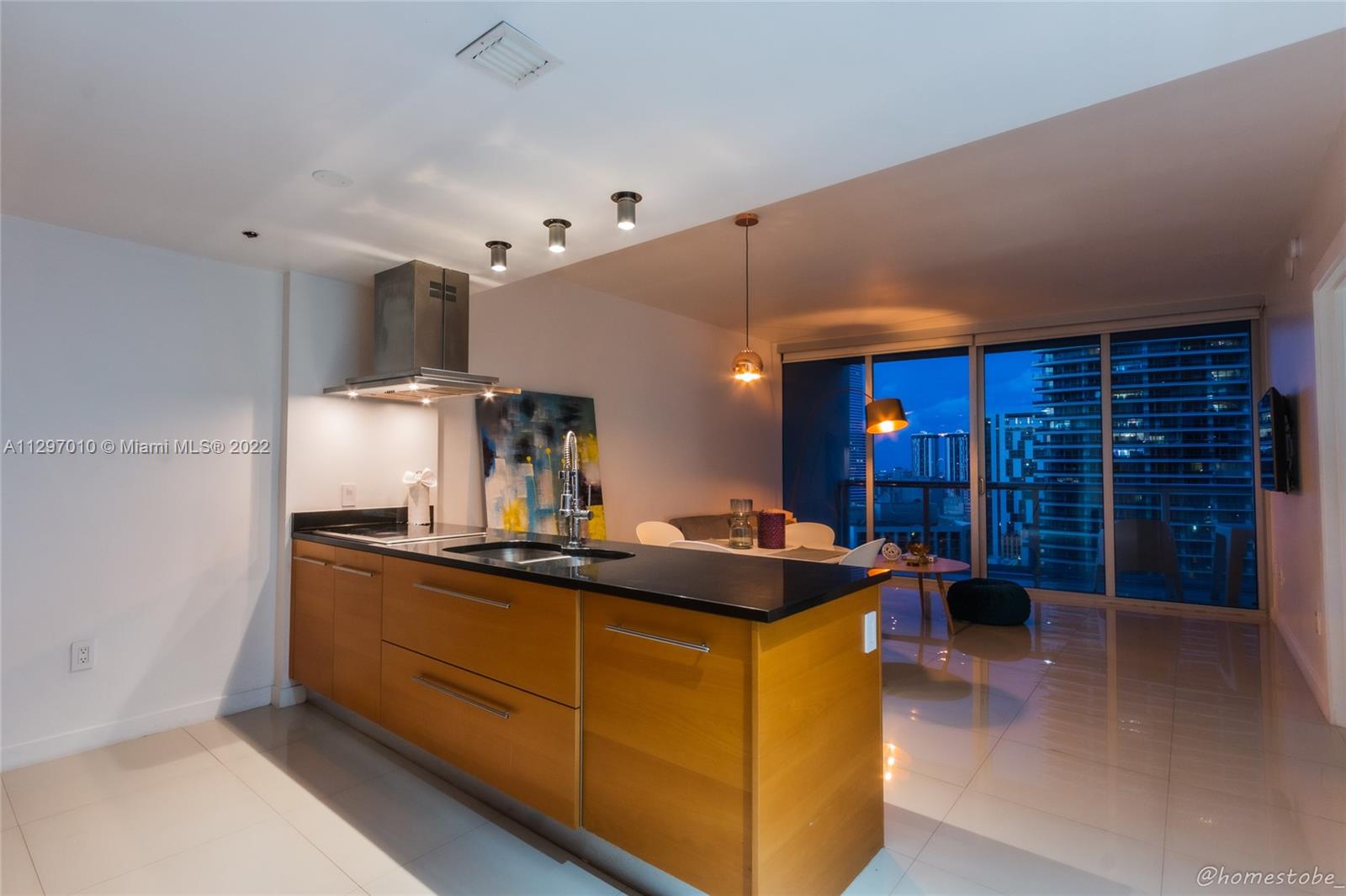 485 Brickell Avenue, Unit 3003 Miami, FL 33131 - Photo 10 of 17 a kitchen with stainless steel appliances granite countertop a sink a stove and a refrigerator