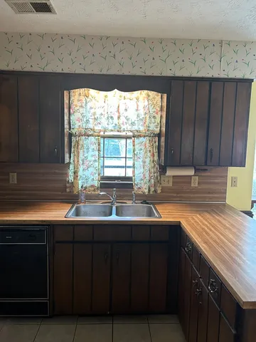 a kitchen with granite countertop a stove and a sink