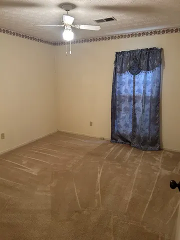 a view of an empty room with a chandelier