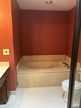 a white toilet sitting next to a bathroom sink