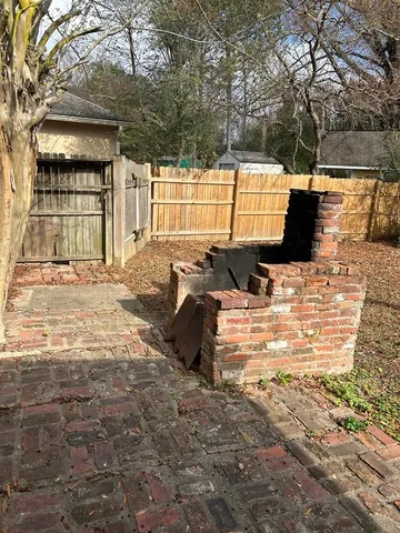 a view of a yard with plants and trees