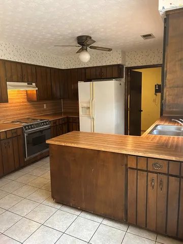 a kitchen with a cabinets and a refrigerator