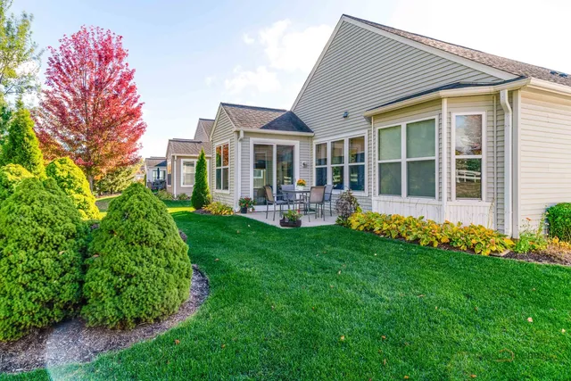 a front view of house with yard and green space