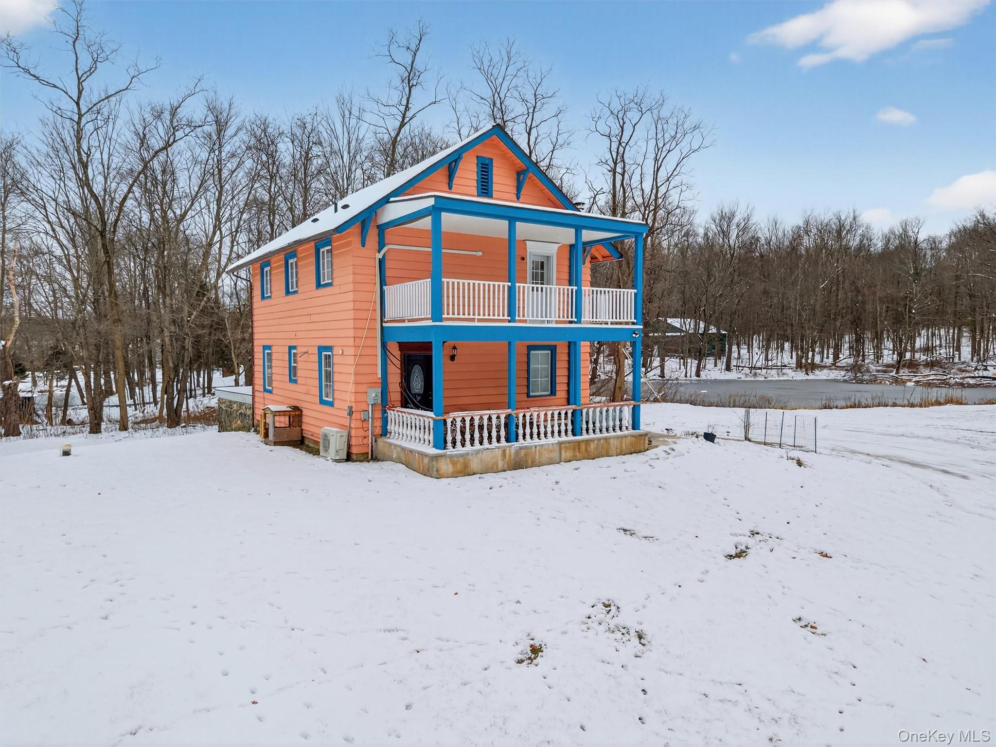 a view of large house with a yard covered in snow