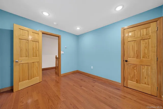 an empty room with wooden floor