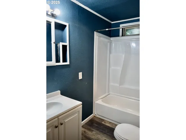 a view of a wooden bench with chairs in wooden deck