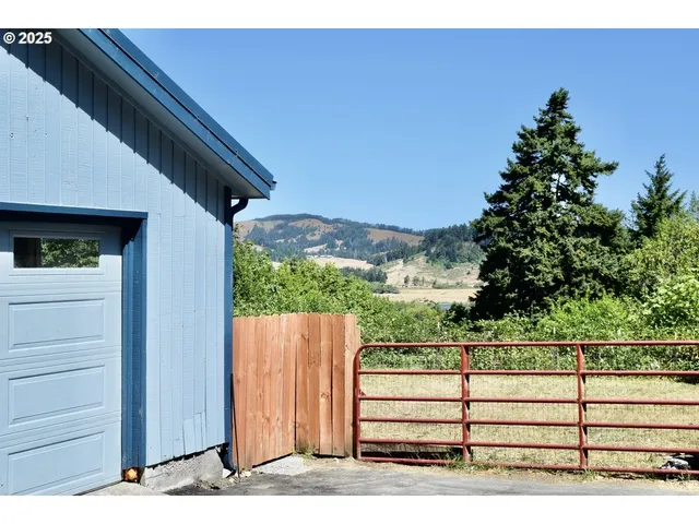a view of a fence and trees
