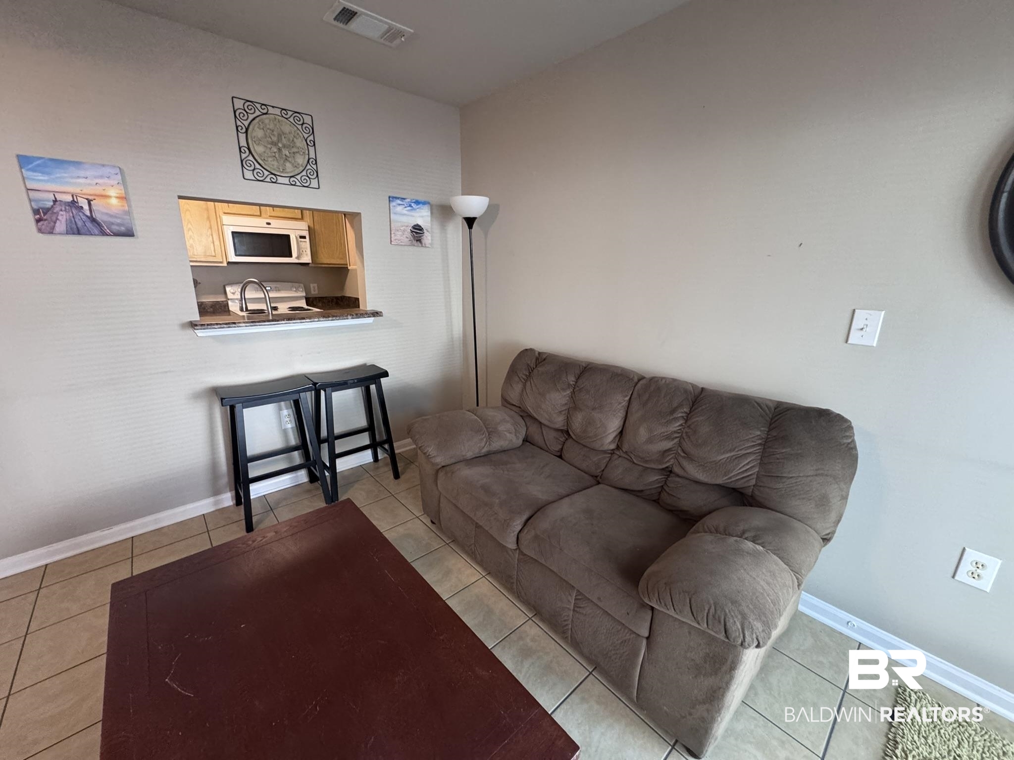 1517 Regency Road, Unit 131 Gulf Shores, AL 36542 - Photo 7 of 21 Living room with light tile patterned floors