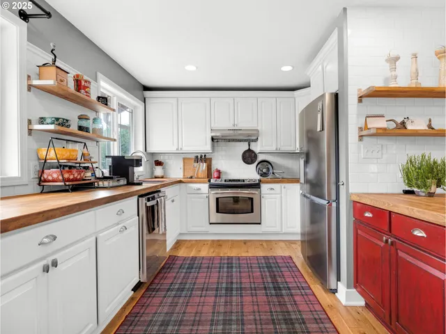 a kitchen with granite countertop white cabinets and white appliances