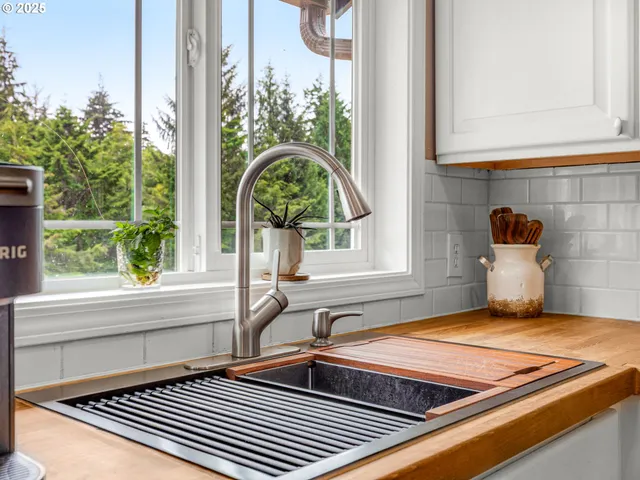 a view of a kitchen with a sink and a window