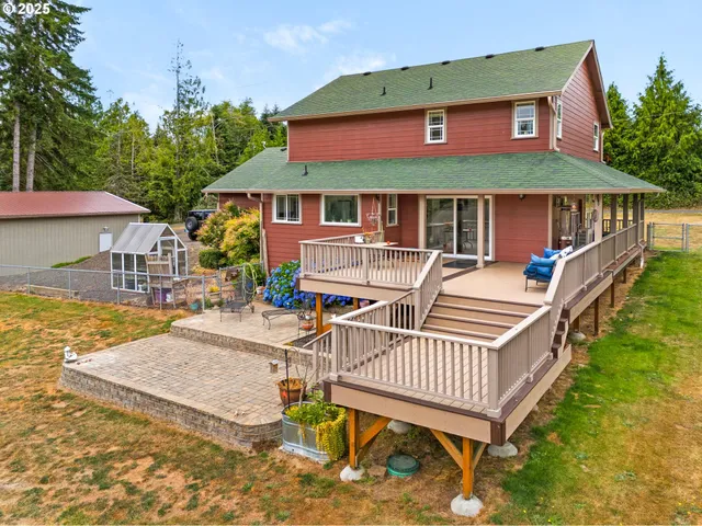 an aerial view of a house with pool and porch