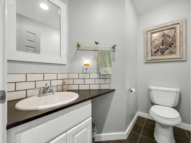 a bathroom with a sink toilet and a mirror