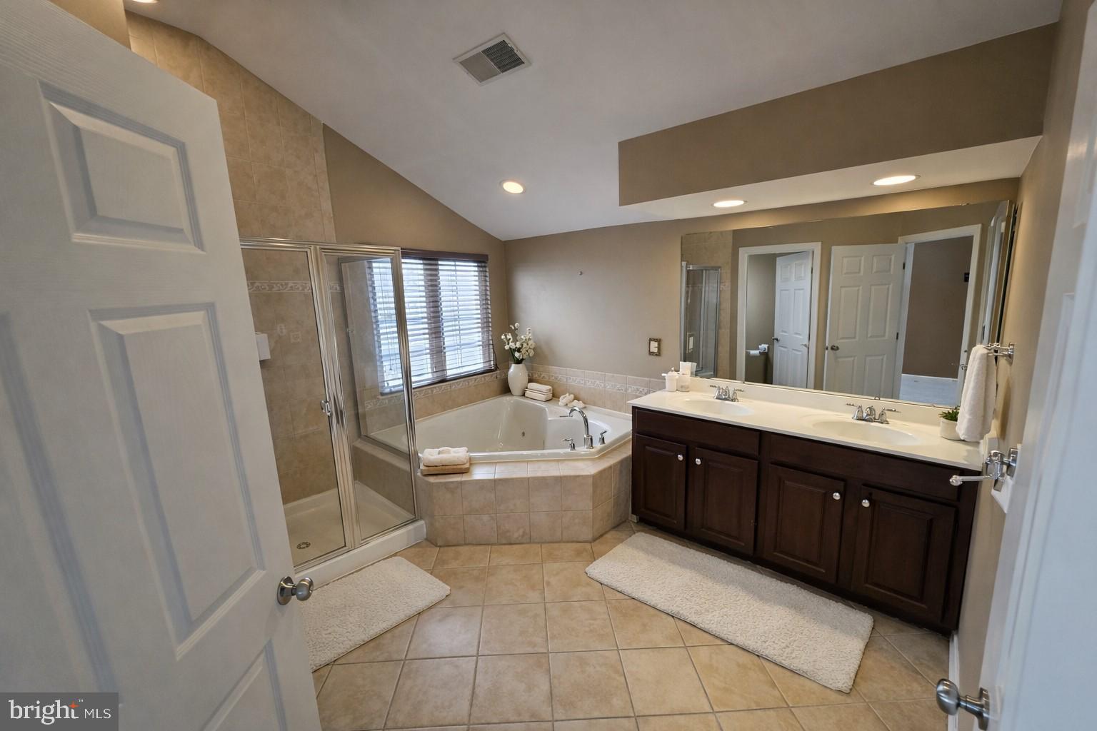 5111 Honeybrook Way Perry Hall, MD 21128 - Photo 13 of 20 a spacious bathroom with a tub sink shower and mirror