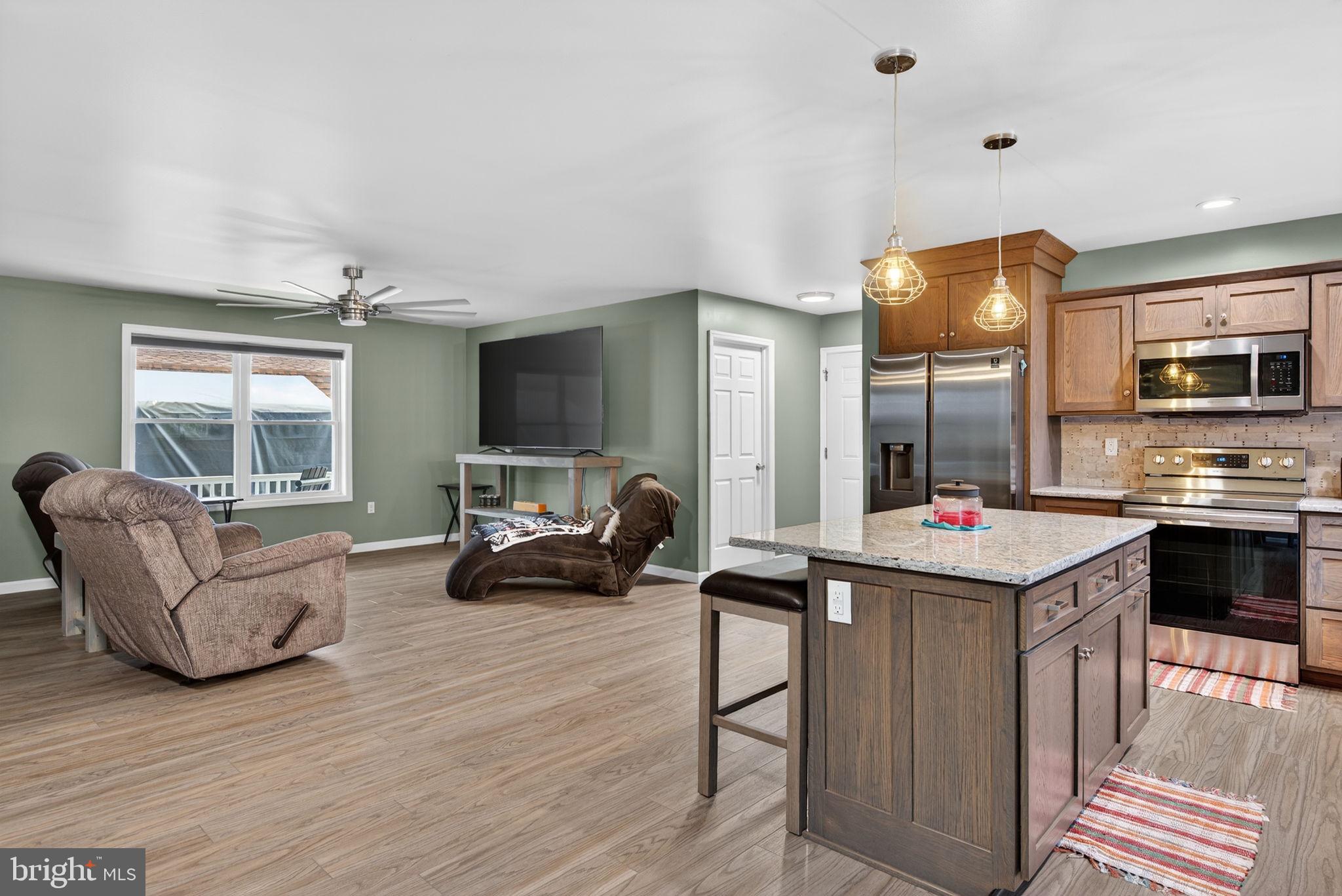 849 Sugar Run Road Millerstown, PA 17062 - Photo 12 of 34 a living room with furniture kitchen and a wooden floor
