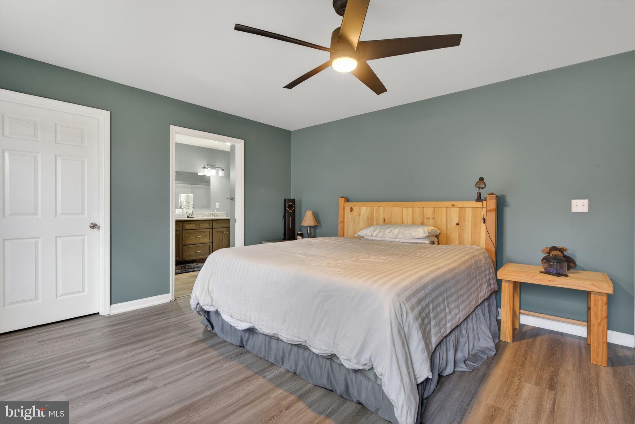 849 Sugar Run Road Millerstown, PA 17062 - Photo 15 of 34 a bedroom with a bed and wooden floor