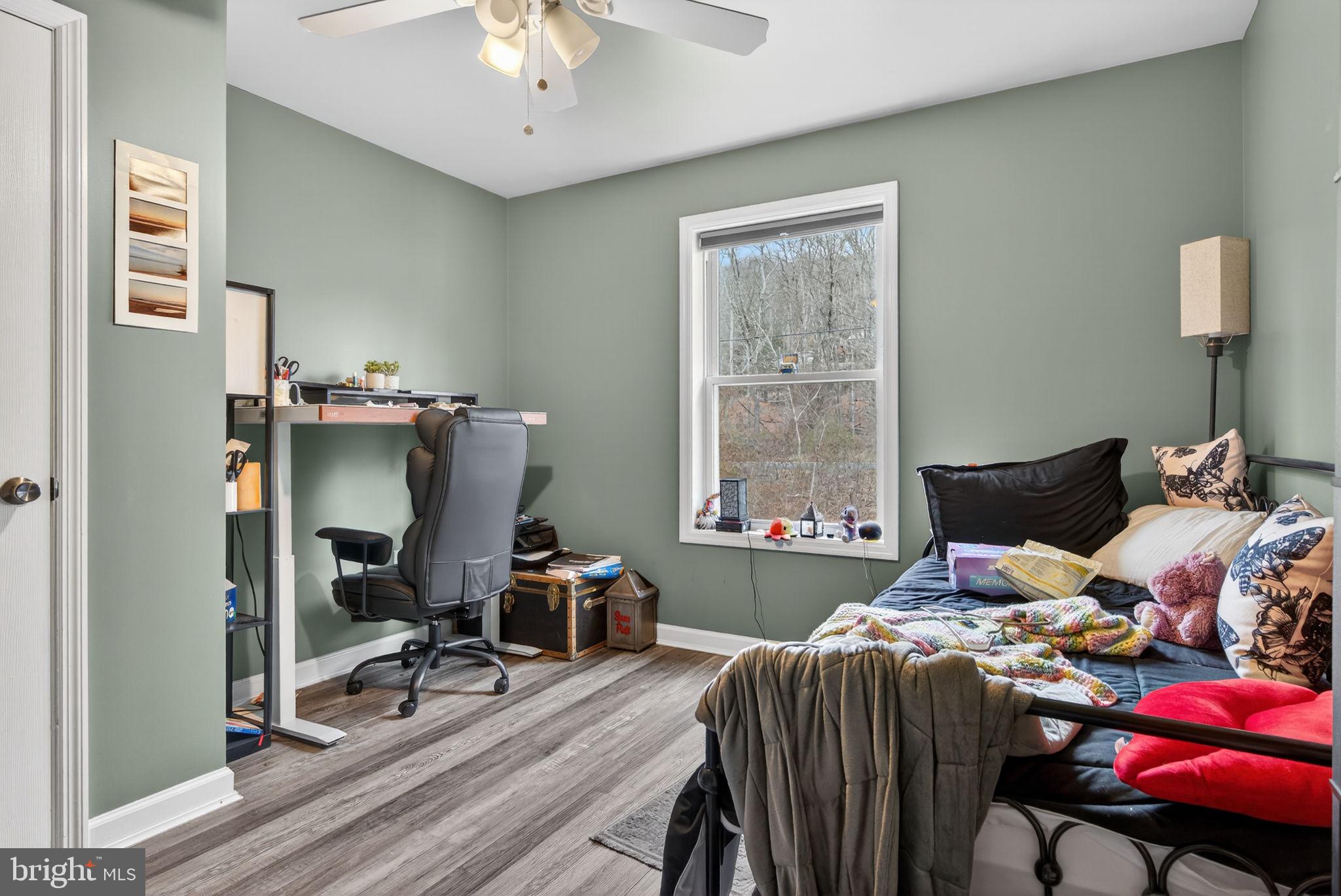 849 Sugar Run Road Millerstown, PA 17062 - Photo 19 of 34 a bedroom with a bed and a chandelier