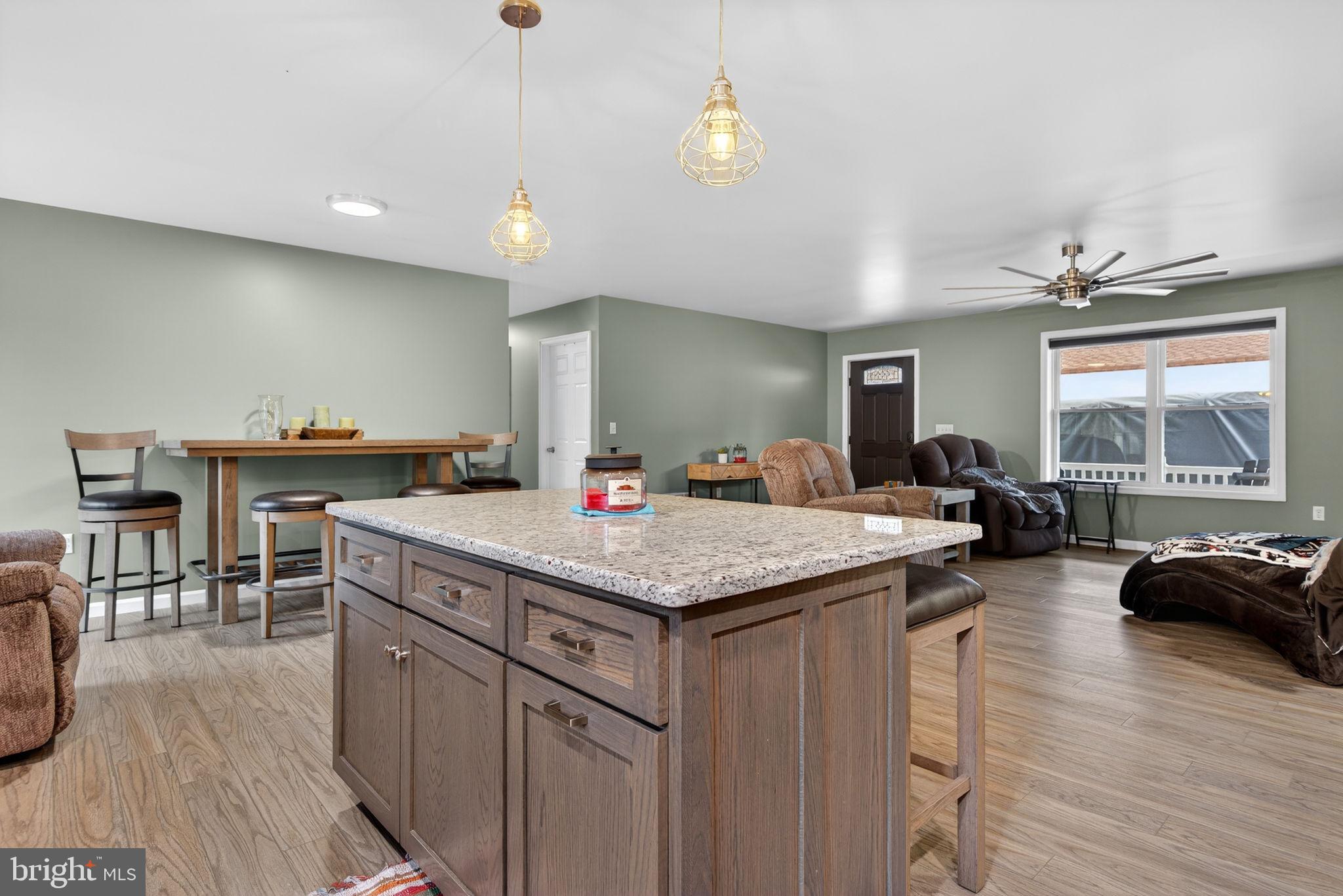 849 Sugar Run Road Millerstown, PA 17062 - Photo 10 of 34 a kitchen with stainless steel appliances granite countertop a kitchen island a stove and a wooden floors