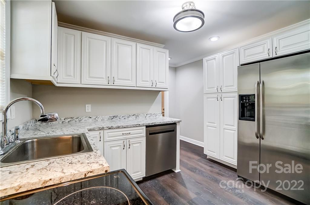 502 Plantation Road Lancaster, SC 29720 - Photo 12 of 44 a kitchen with granite countertop a stove and a refrigerator