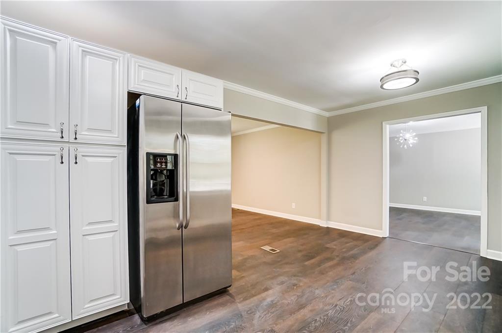 502 Plantation Road Lancaster, SC 29720 - Photo 15 of 44 an empty room with wooden floor and cabinet