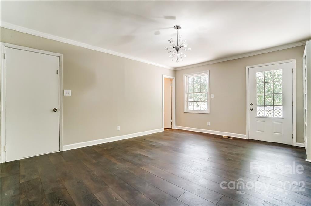 502 Plantation Road Lancaster, SC 29720 - Photo 18 of 44 a view of an empty room with window and wooden floor