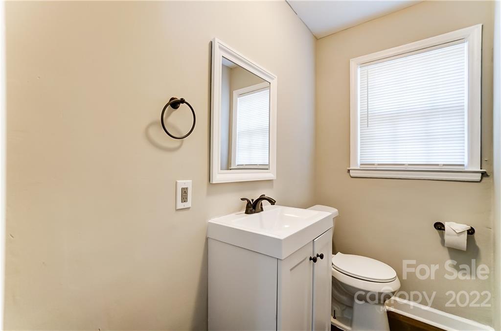 502 Plantation Road Lancaster, SC 29720 - Photo 20 of 44 a bathroom with a toilet sink and mirror