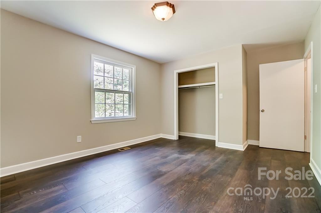 502 Plantation Road Lancaster, SC 29720 - Photo 22 of 44 an empty room with wooden floor and windows
