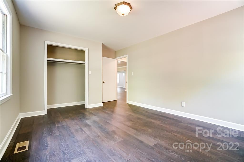 502 Plantation Road Lancaster, SC 29720 - Photo 23 of 44 an empty room with wooden floor and windows