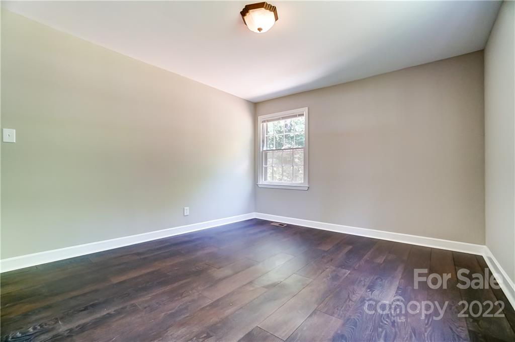502 Plantation Road Lancaster, SC 29720 - Photo 24 of 44 an empty room with wooden floor and windows
