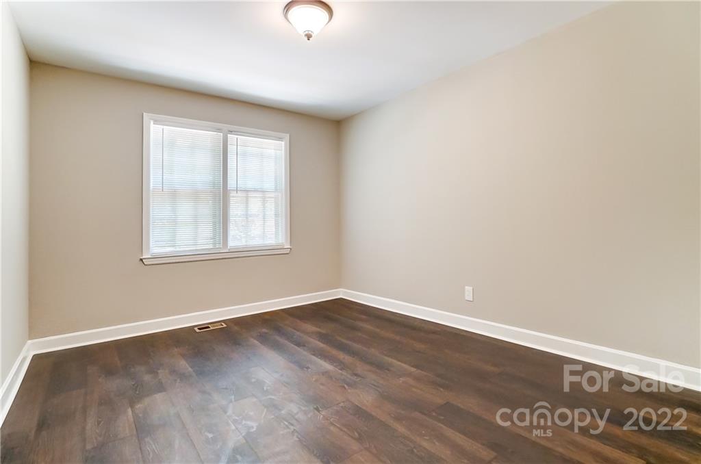 502 Plantation Road Lancaster, SC 29720 - Photo 25 of 44 an empty room with wooden floor and windows