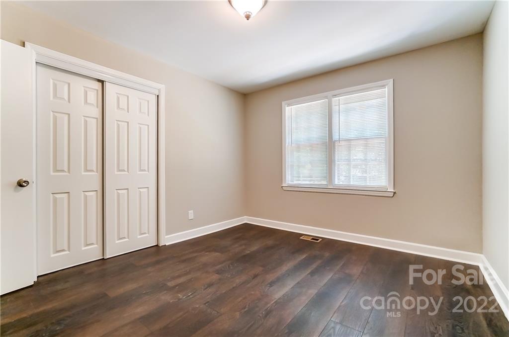 502 Plantation Road Lancaster, SC 29720 - Photo 26 of 44 a view of an empty room with wooden floor and a window
