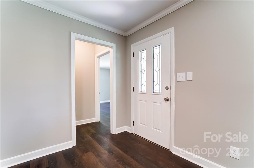502 Plantation Road Lancaster, SC 29720 - Photo 3 of 44 an empty room with wooden floor and a window