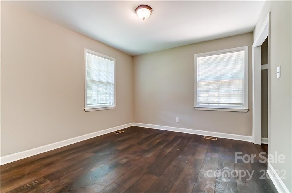 502 Plantation Road Lancaster, SC 29720 - Photo 32 of 44 an empty room with wooden floor and windows