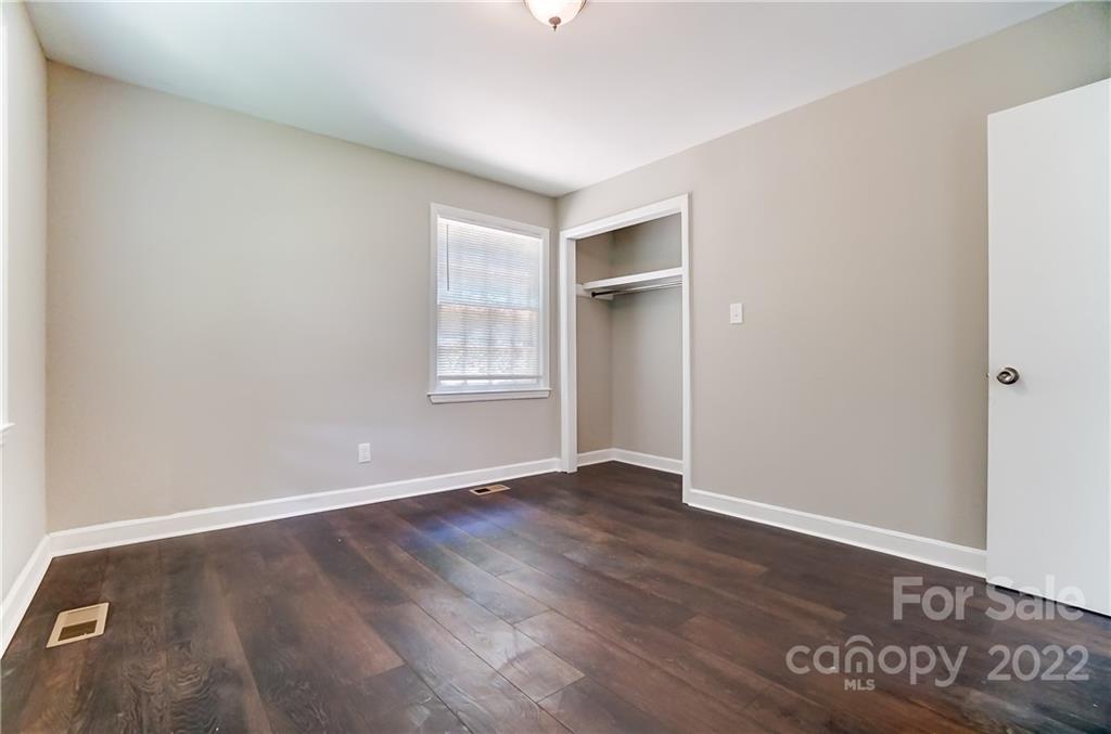 502 Plantation Road Lancaster, SC 29720 - Photo 33 of 44 an empty room with wooden floor and windows