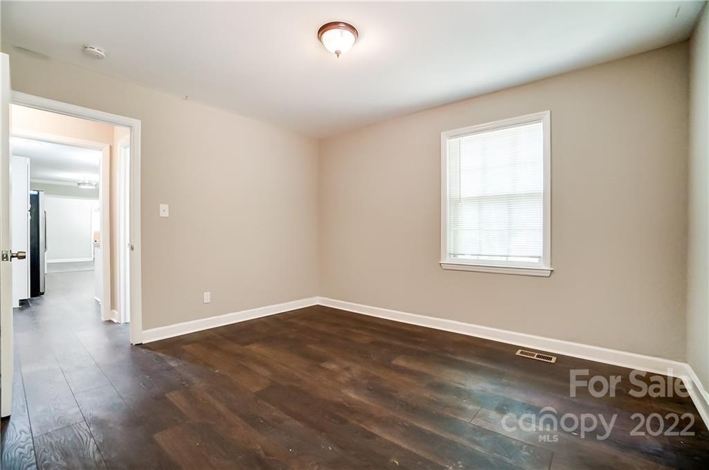 502 Plantation Road Lancaster, SC 29720 - Photo 35 of 44 an empty room with wooden floor and windows