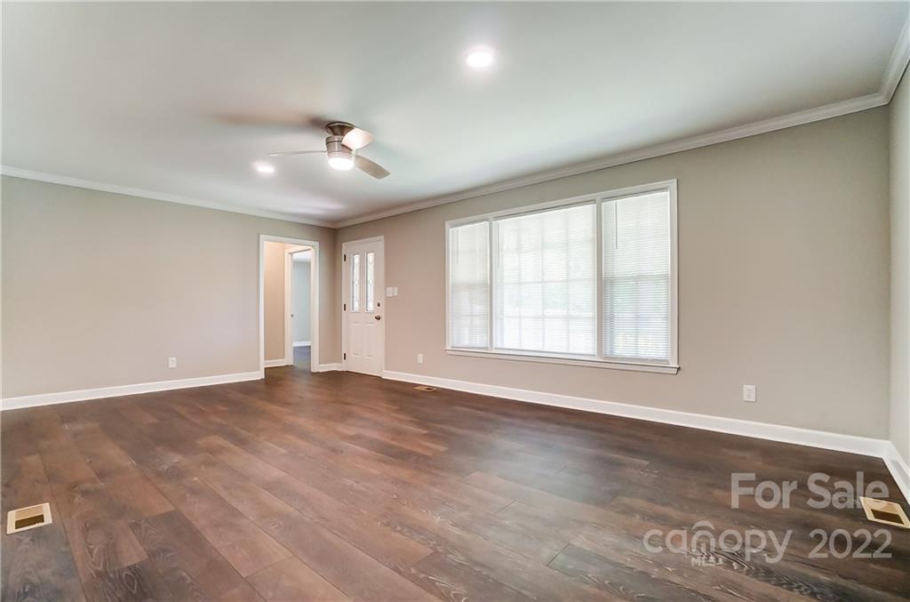 502 Plantation Road Lancaster, SC 29720 - Photo 5 of 44 an empty room with wooden floor and windows