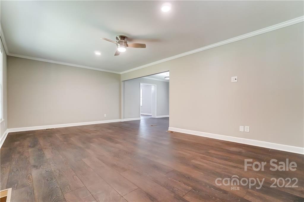 502 Plantation Road Lancaster, SC 29720 - Photo 6 of 44 an empty room with wooden floor and windows
