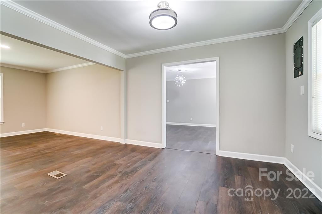 502 Plantation Road Lancaster, SC 29720 - Photo 10 of 44 an empty room with wooden floor and windows