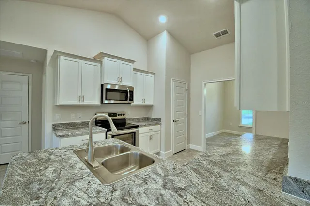 an empty room with closet and natural light
