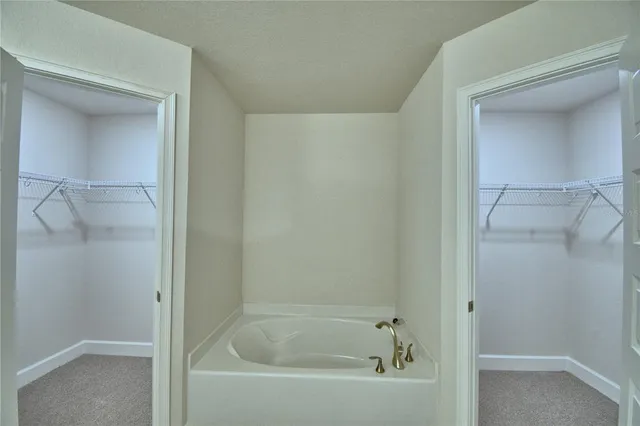 a bathroom with a granite countertop sink a toilet and a mirror
