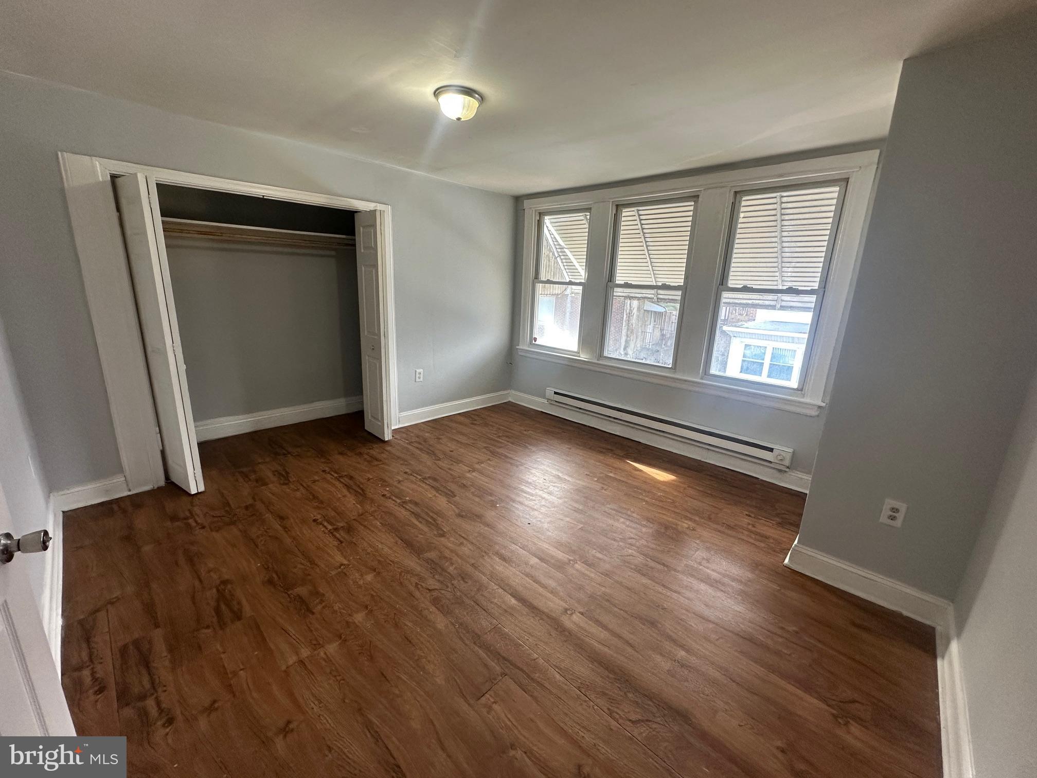 609 North Wilton Street Philadelphia, PA 19131 - Photo 13 of 15 an empty room with wooden floor and windows