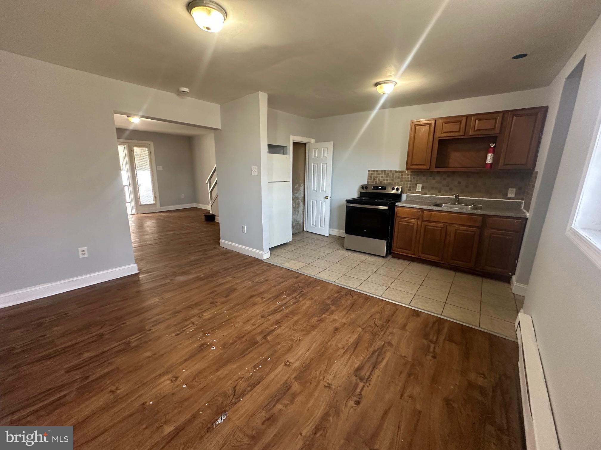 609 North Wilton Street Philadelphia, PA 19131 - Photo 10 of 15 a large kitchen with granite countertop a large counter top space and stainless steel appliances