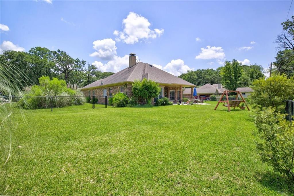 111 Trailwood Road Enchanted Oaks, TX 75156 - Photo 25 of 33 a view of a house with a big yard