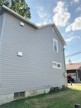 a view of a house with a yard and sitting area