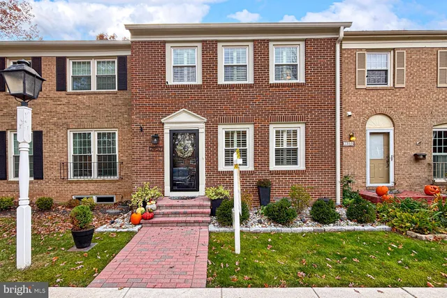 a front view of a house with yard and green space