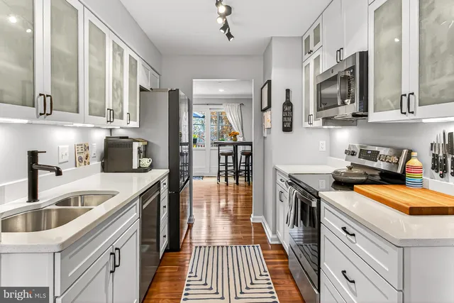 a kitchen with stainless steel appliances granite countertop a sink and a stove