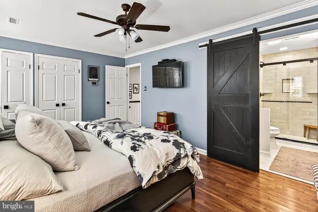 a bedroom with a bed and a refrigerator